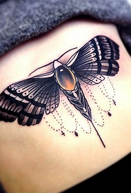 A moth tattoo at the waist