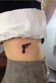 seksi i femrës me model të bukur tatuazhesh me pistoletë me pistoletë