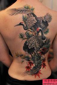 A very classic full-backed crane tattoo
