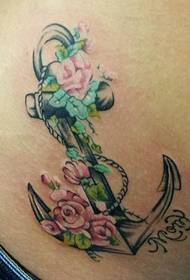 Female waist anchor and colored flower tattoo