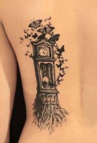 vecchio orologio nero a forma di albero con motivo a farfalla