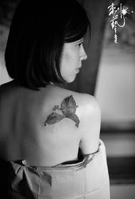 girl back leaf tattoo