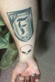 Татуировка с изображением щита на руке мальчика и татуировка с изображением щита