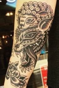 Tetovirana roka znotraj ženskega dekleta s sliko tatoo ježa in volka