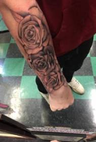 Rose tattoo illustrasie boy's arm op swartgrys roos tattoo foto