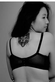 Female back with a black and white kitten's head tattoo picture