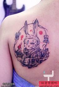 Woman back bunny rose tattoo tattoo