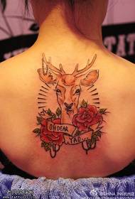 Woman back colored antelope rose tattoo work
