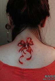Girl with a colorful bow tattoo on the back
