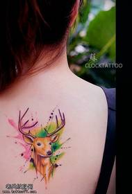 Woman's back colored antelope tattoos are shared by tattoos