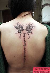 Cô gái xinh đẹp với hình xăm con bướm và chữ trên lưng
