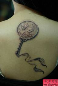классическая маленькая веерная татуировка на спине девушки