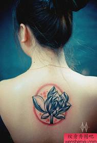 Bela kaj bela lotusa tatuaje sur la dorso de la knabino
