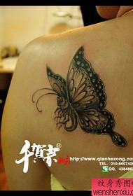 Patrún tattoo féileacán dubh agus bán álainn ar chúl na mná áille