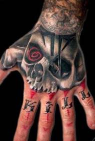 Hand mysterieuze schedel met belettering tattoo patroon