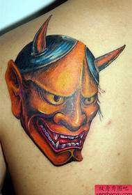 un tatuaggio fenice dorata sul retro