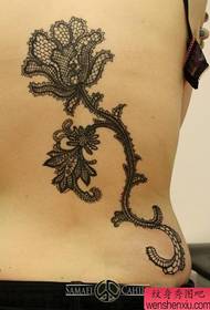 Beautiful lace lotus tattoo on the back of the girl