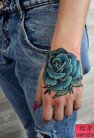 Woman hand rose tattoo work