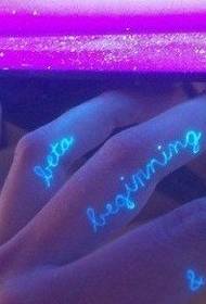 Kaunis englantilainen fluoresoiva kirje tatuointi kuva sormella