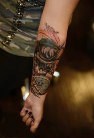 Póca fuinseog retro dubh ag breathnú ar phictiúr tattoo