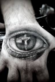Zadní strana ruky odráží tetování Ježíše na kříži