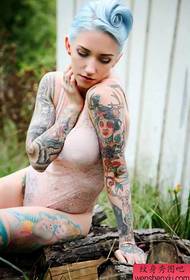 Tattoo show kuva suosittelee naiselle seksikästä kukkavartta Tattoo-mallia
