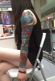 Long-haired Meedchen mat Blummenarm Tattoo Tattooen