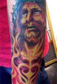 Arm colored Jesus tattoo in flames
