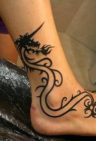 a personalized dragon tattoo at the ankle