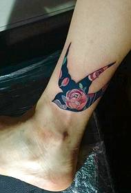 Swallow tattoo wearing a flower dress