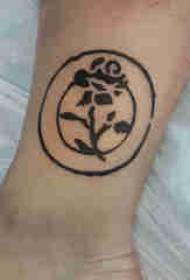 Panda matako ya wavulana wenye tattoo kwenye pande zote na picha za rose za maua