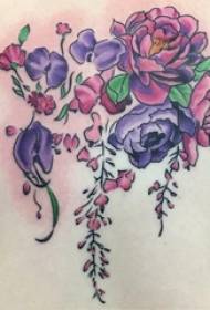 small fresh plant Tattooed girl on the back of a colored plant tattoo picture