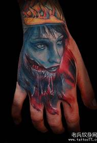 a bloody portrait tattoo on the back of the hand
