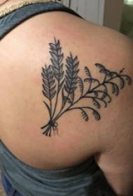 bizkarreko tatuaje emakumezko neska landare beltzaren tatuajearen atzeko aldean