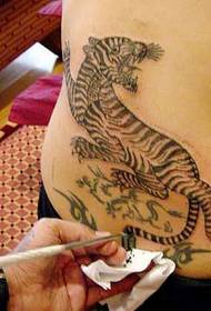 American movie star Angelina behind the tiger tattoo