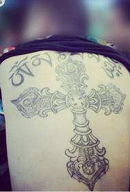 ragazzo dietro l'immagine del modello del tatuaggio croce religiosa