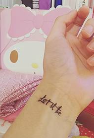 English personality tattoo on the girl's wrist