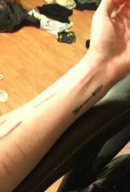 Tatuaggio da polso europeo e americano da polso da ragazza sulla foto di tatuaggio freccia nera