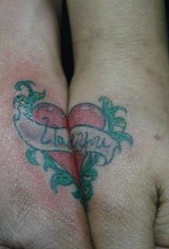 heart-shaped tattoo on the wrist of the couple