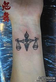 girl wrist a classic Libra symbol tattoo pattern