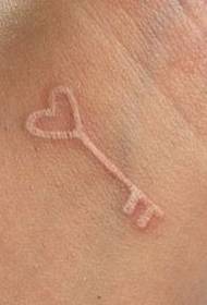 invisible white wrist key tattoo pattern