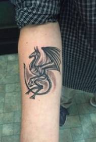 Bras de garçon sur une ligne simple piquée noire petit animal volant image de tatouage de dragon