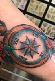 Berniuko ranka ant dažytos kompaso tatuiruotės paveikslo