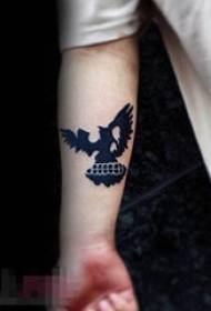 Schoolboy arm on black silhouette eagle small pattern tattoo picture