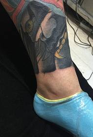 Traditional small-sized tattoos on the calf