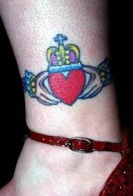 Tornozelo mão colorido segurando coração em forma de coroa padrão de tatuagem