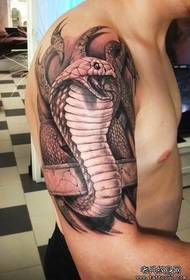 ein Kobra-Tattoo auf dem großen Arm