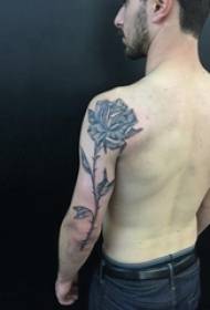 Berniuko rankos ant juodo taško erškėčių paprasto abstraktaus augalo gėlių tatuiruotės paveikslėlis