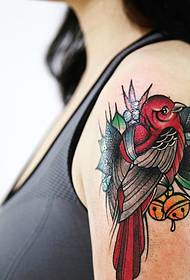 Moda ragazza con un tatuaggio colorato uccello tatuaggio