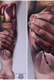 Braccio candela colorata in stile realistico con tatuaggio a mano pregante